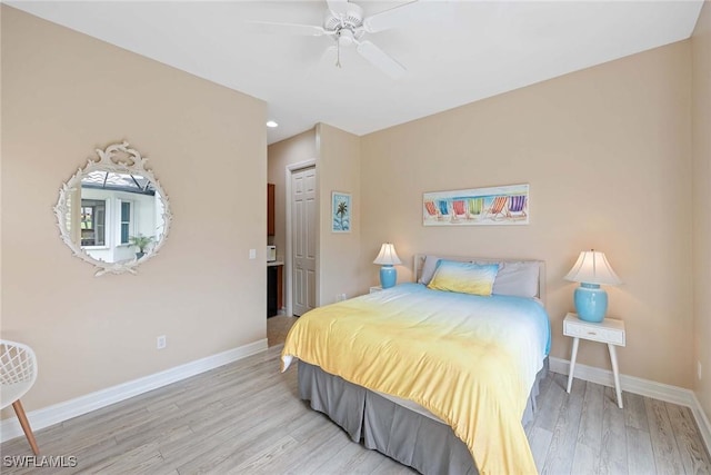 bedroom featuring a closet, light hardwood / wood-style flooring, and ceiling fan