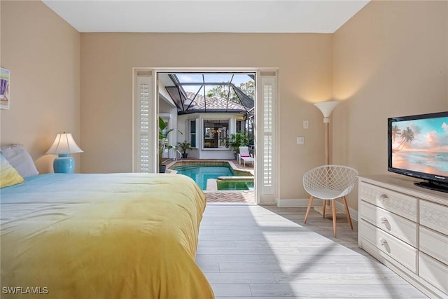 bedroom featuring light hardwood / wood-style floors and access to outside