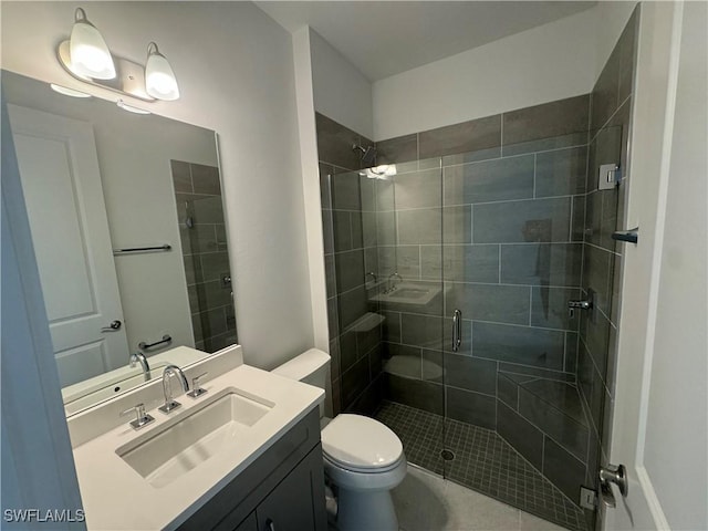 bathroom with vanity, an enclosed shower, and toilet