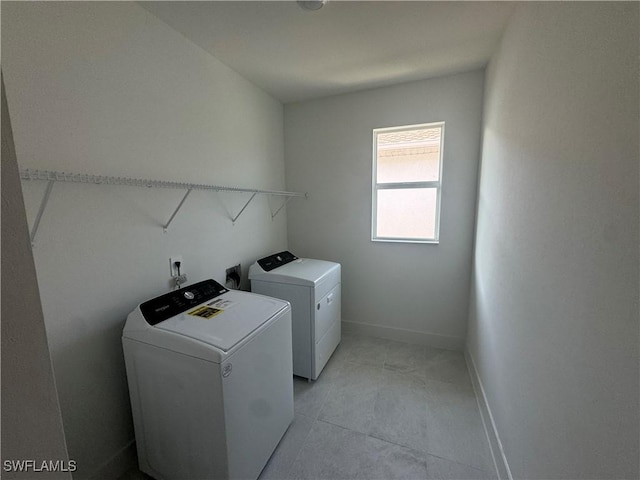 clothes washing area featuring washer and dryer