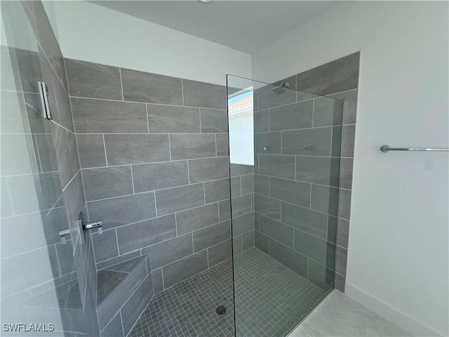 bathroom with a tile shower