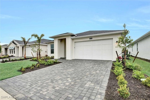 view of front of property with a garage and a front yard