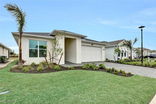 view of front of home featuring a garage and a front yard