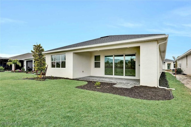 rear view of house with a yard and a patio area