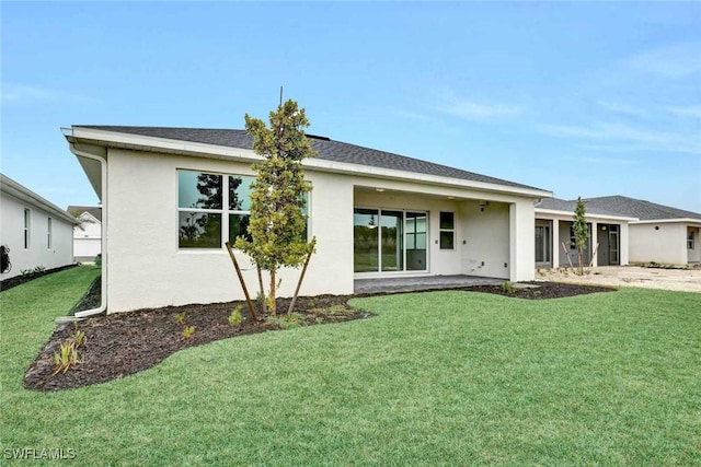 rear view of house featuring a lawn