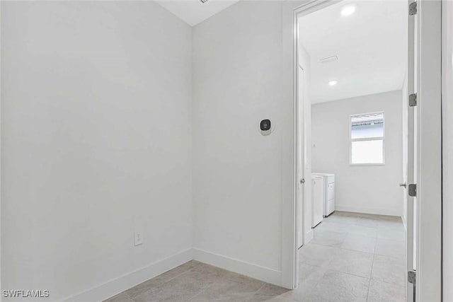 hall featuring light tile patterned flooring