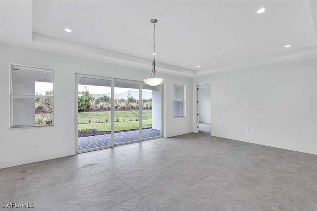 empty room featuring a tray ceiling