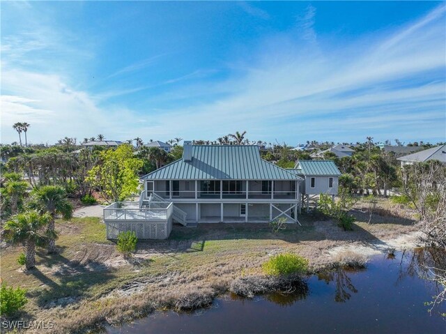 back of house featuring a water view