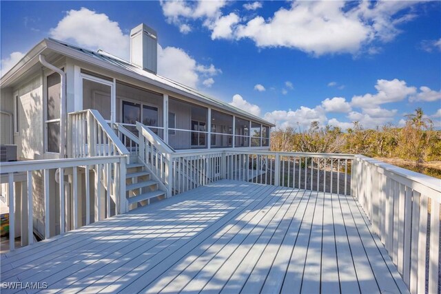 wooden deck with a sunroom