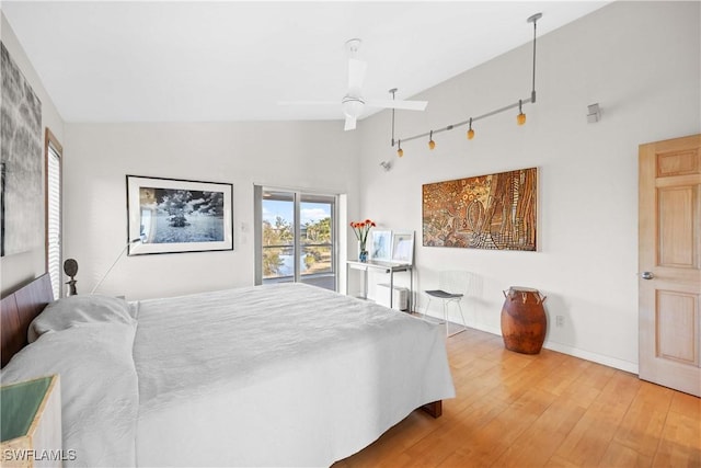 bedroom with hardwood / wood-style flooring and high vaulted ceiling