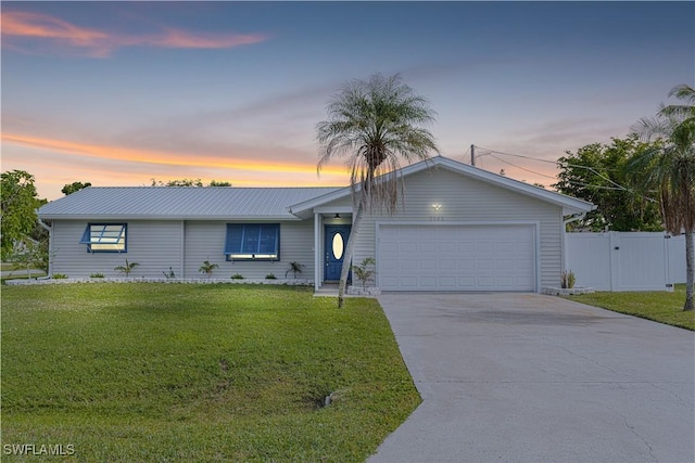 single story home with a yard and a garage