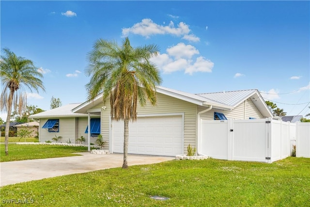 view of front of property with a front yard and a garage