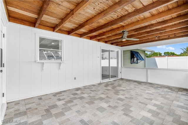 unfurnished sunroom with ceiling fan, beam ceiling, and wood ceiling