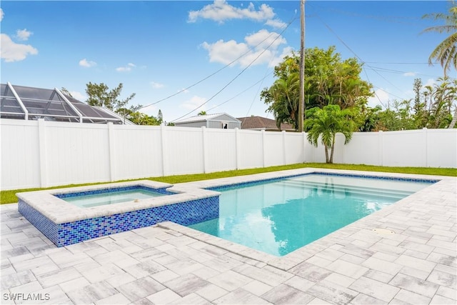 view of swimming pool with an in ground hot tub and a patio