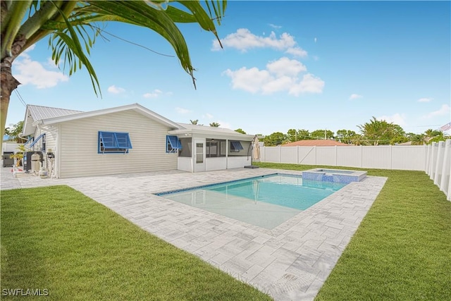 view of pool featuring an in ground hot tub, a yard, a patio area, and a sunroom