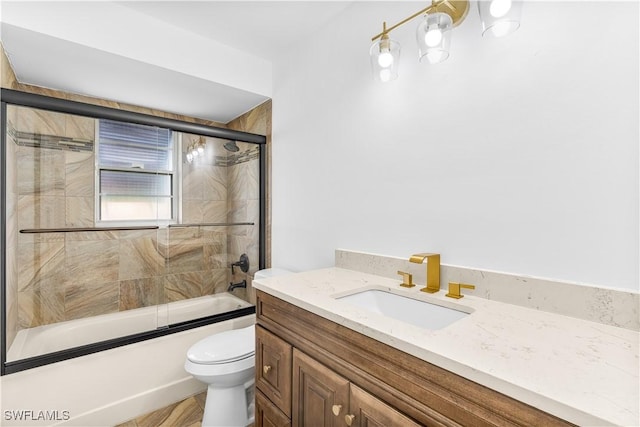 full bathroom with toilet, vanity, and combined bath / shower with glass door