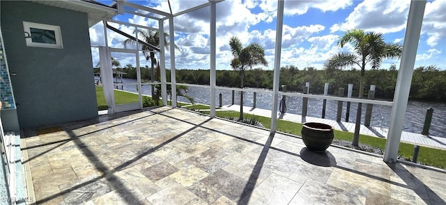 unfurnished sunroom featuring a water view