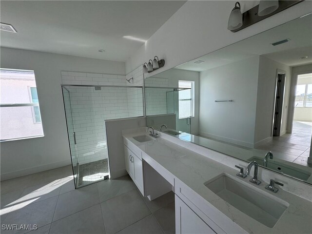 bathroom featuring vanity, tile patterned floors, and a shower with door