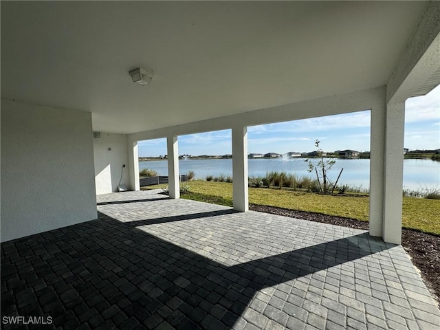 view of patio with a water view