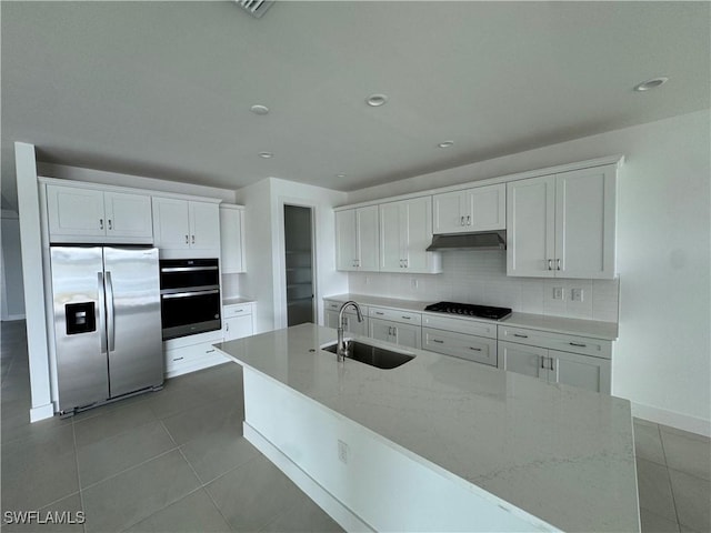 kitchen with sink, stainless steel fridge with ice dispenser, light tile patterned floors, light stone counters, and white cabinetry