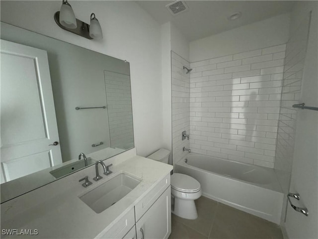 full bathroom featuring tile patterned floors, tiled shower / bath combo, toilet, and vanity