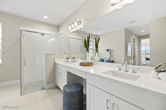 full bathroom featuring a stall shower, connected bathroom, tile patterned flooring, and a sink