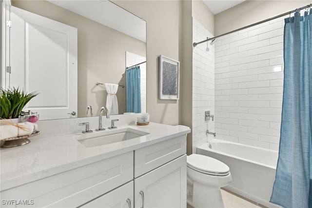bathroom featuring toilet, shower / bath combo with shower curtain, and vanity
