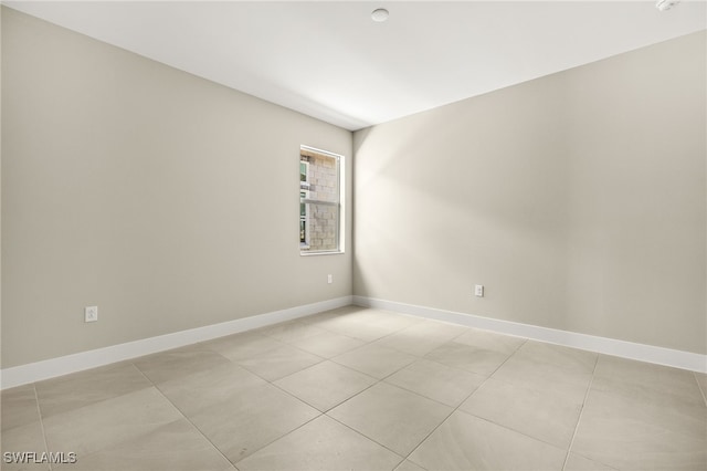 unfurnished room featuring baseboards