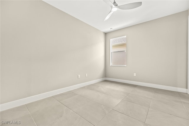 spare room featuring light tile patterned flooring, baseboards, and ceiling fan
