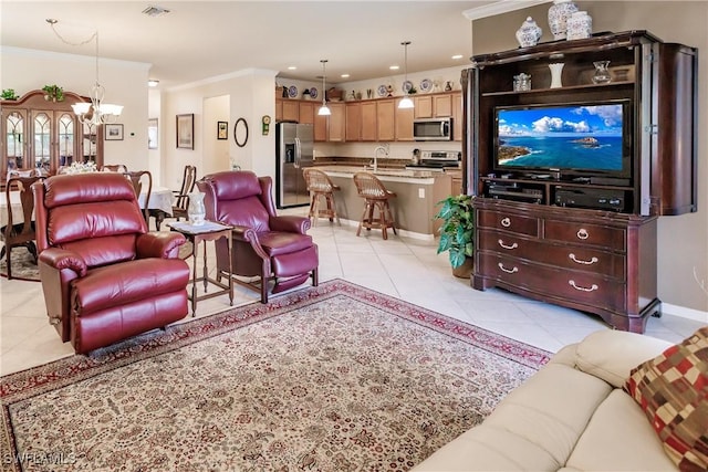 tiled living room featuring sink, crown molding, and a chandelier