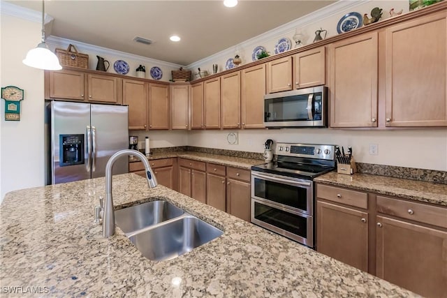 kitchen featuring crown molding, sink, appliances with stainless steel finishes, decorative light fixtures, and light stone counters