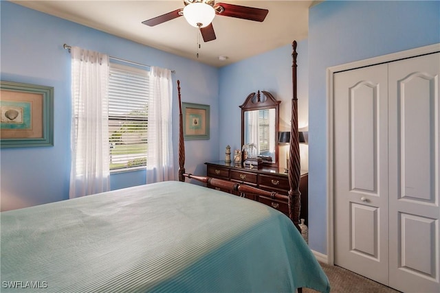 carpeted bedroom with ceiling fan and a closet