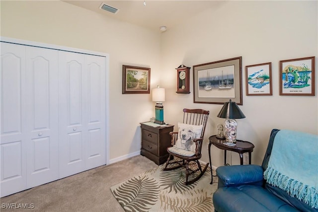 living area featuring light carpet