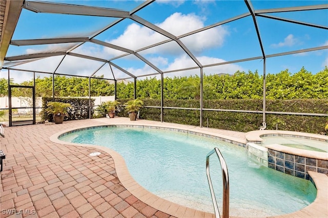 view of swimming pool with a lanai, an in ground hot tub, and a patio