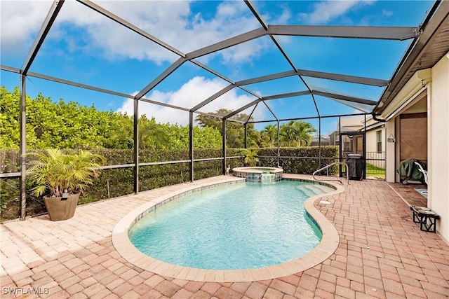 view of pool with glass enclosure, an in ground hot tub, and a patio