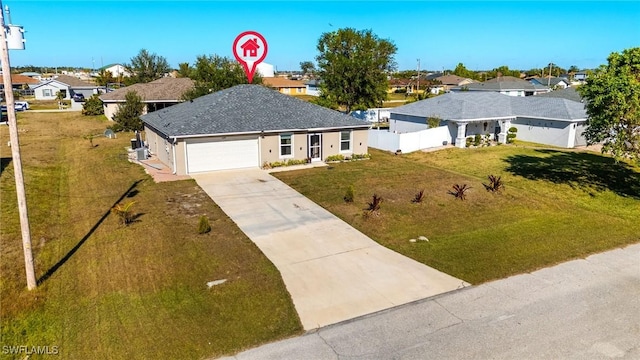 view of front of home featuring a garage and a front lawn