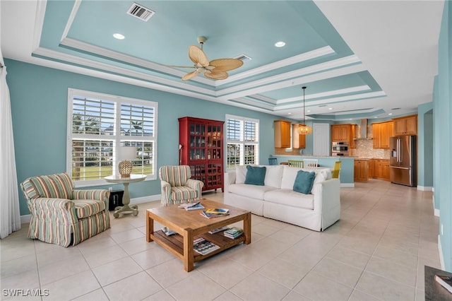 7532 Lake Valencia Ct Unit 5B, Fort Myers Beach, FL 33931 - living room with a ceiling fan, visible vents, light tile patterned floors, and a raised ceiling