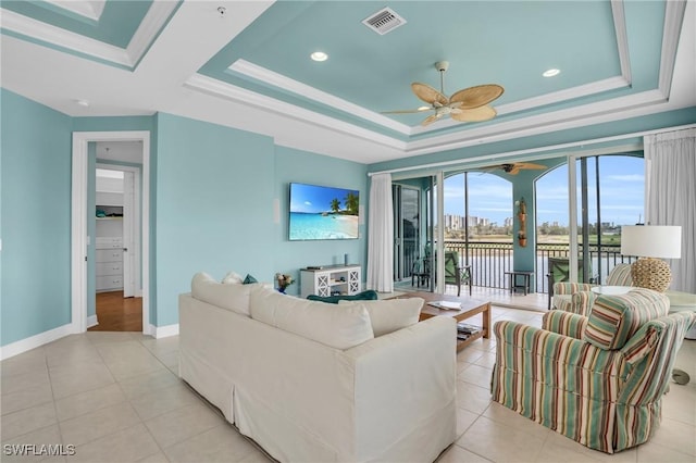 7532 Lake Valencia Ct Unit 5B, Fort Myers Beach, FL 33931 - living area featuring visible vents, baseboards, ceiling fan, a raised ceiling, and light tile patterned floors