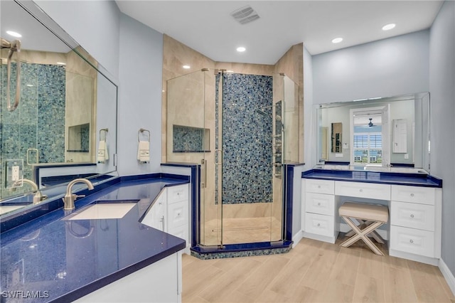 7532 Lake Valencia Ct Unit 5B, Fort Myers Beach, FL 33931 - full bath with a stall shower, vanity, wood finished floors, visible vents, and recessed lighting