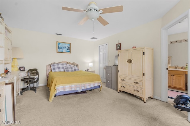 bedroom featuring sink, ceiling fan, connected bathroom, light colored carpet, and a closet