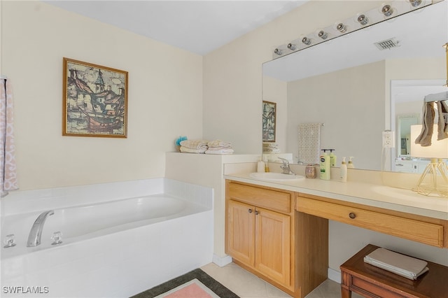 bathroom featuring tile patterned flooring, a bath, and vanity