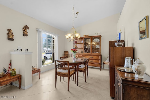 dining area with a chandelier and lofted ceiling