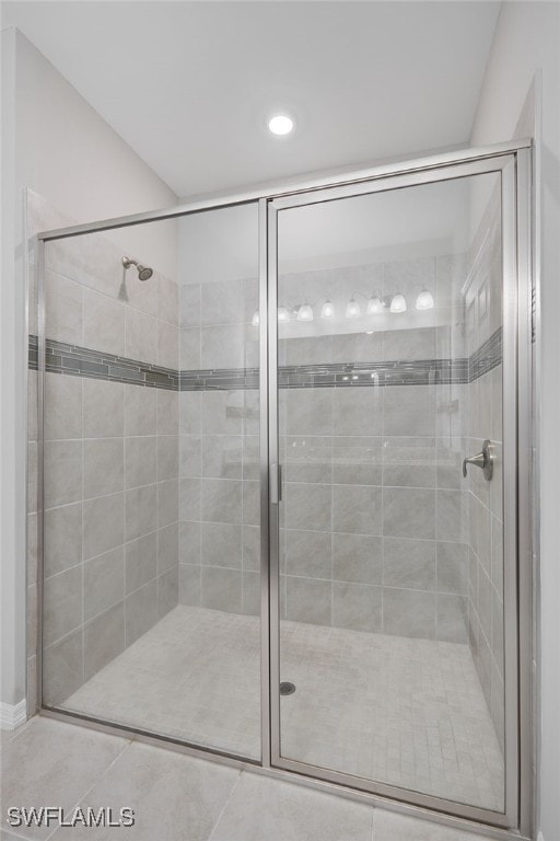 bathroom featuring tile patterned floors and a shower with shower door