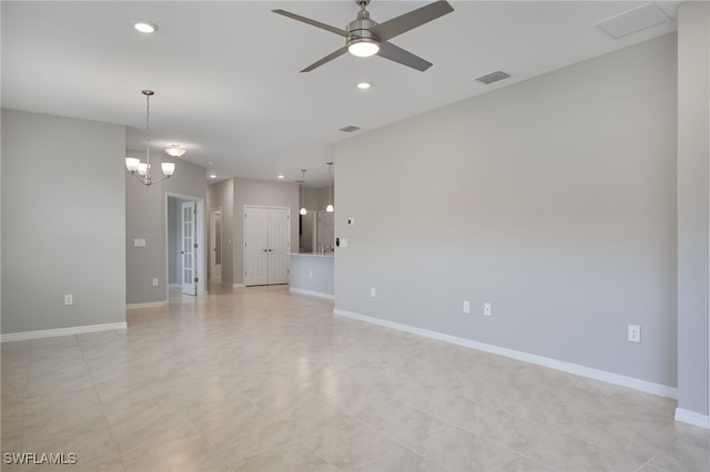 unfurnished room featuring ceiling fan with notable chandelier