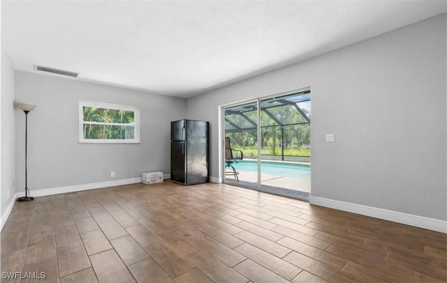 unfurnished living room with hardwood / wood-style flooring and a wealth of natural light