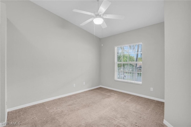 carpeted empty room featuring ceiling fan