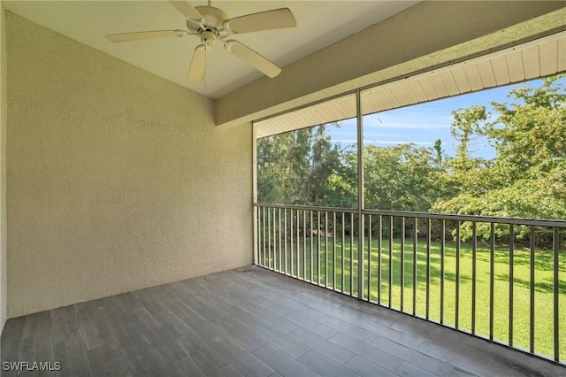 unfurnished sunroom featuring ceiling fan