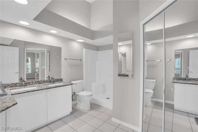 bathroom featuring tile patterned floors, vanity, and toilet