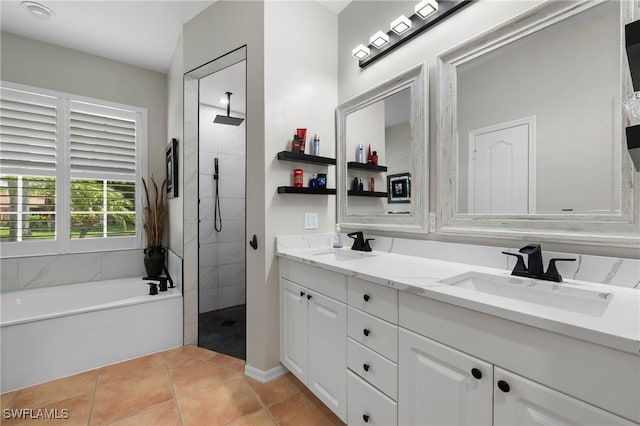 bathroom with tile patterned flooring, vanity, and separate shower and tub