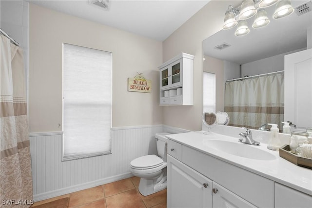 bathroom featuring tile patterned flooring, vanity, and toilet